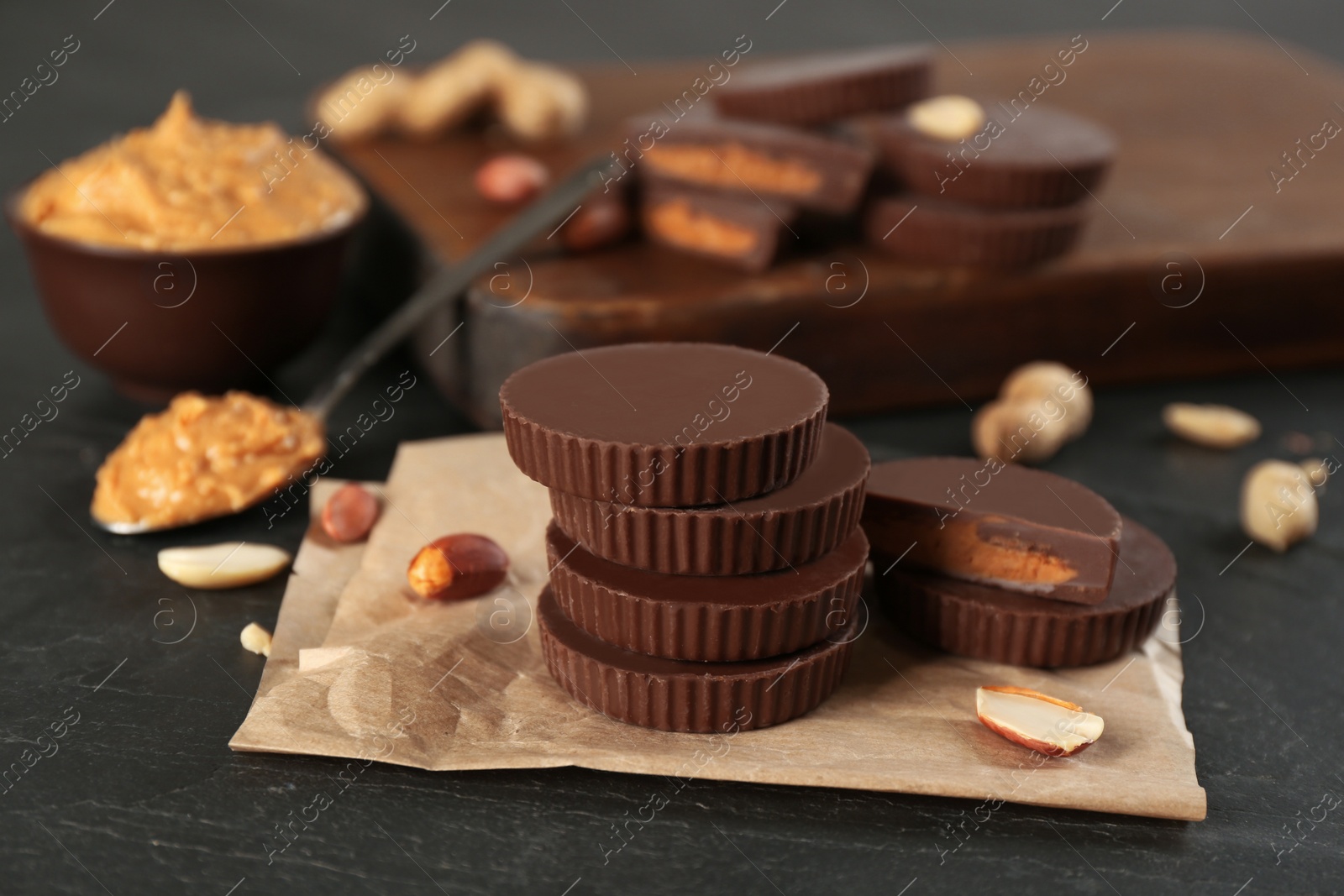 Photo of Delicious peanut butter cups on black table