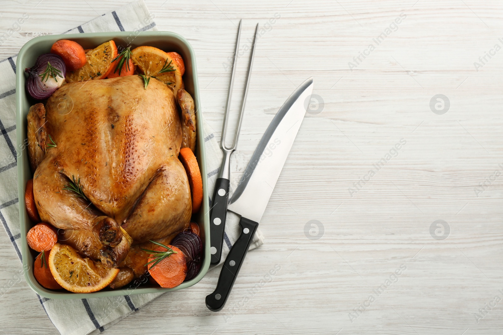 Photo of Delicious chicken with oranges and vegetables on white wooden table, flat lay. Space for text