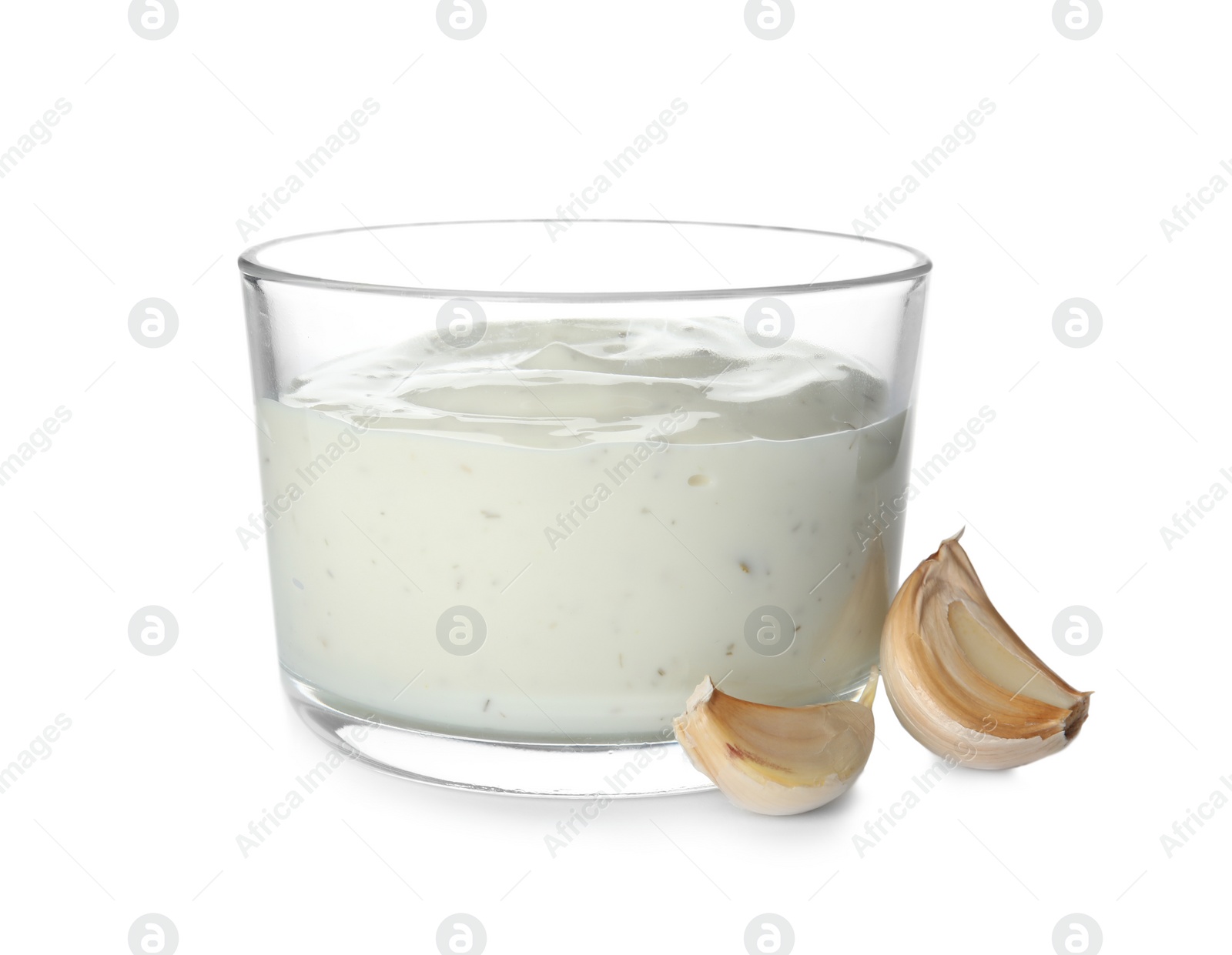 Photo of Bowl of homemade sauce and garlic cloves isolated on white