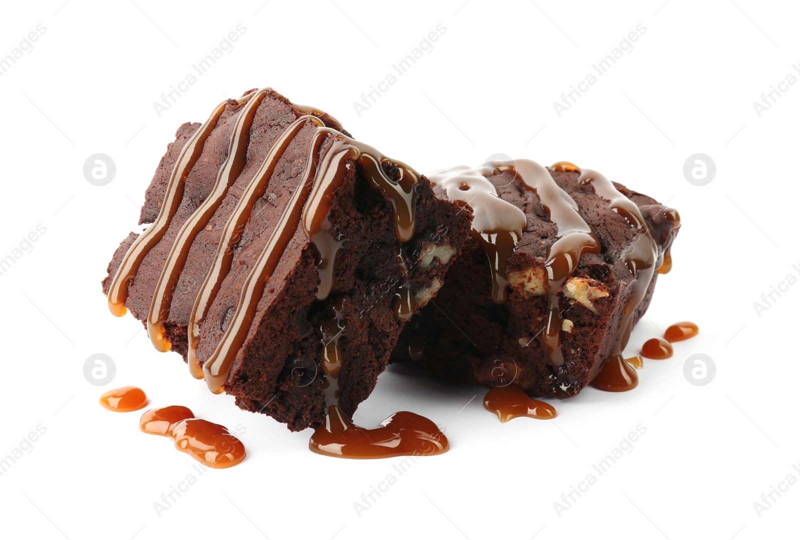 Photo of Delicious chocolate brownies with nuts and caramel sauce on white background