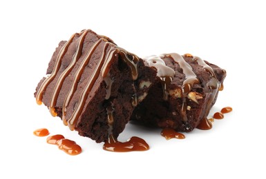 Delicious chocolate brownies with nuts and caramel sauce on white background