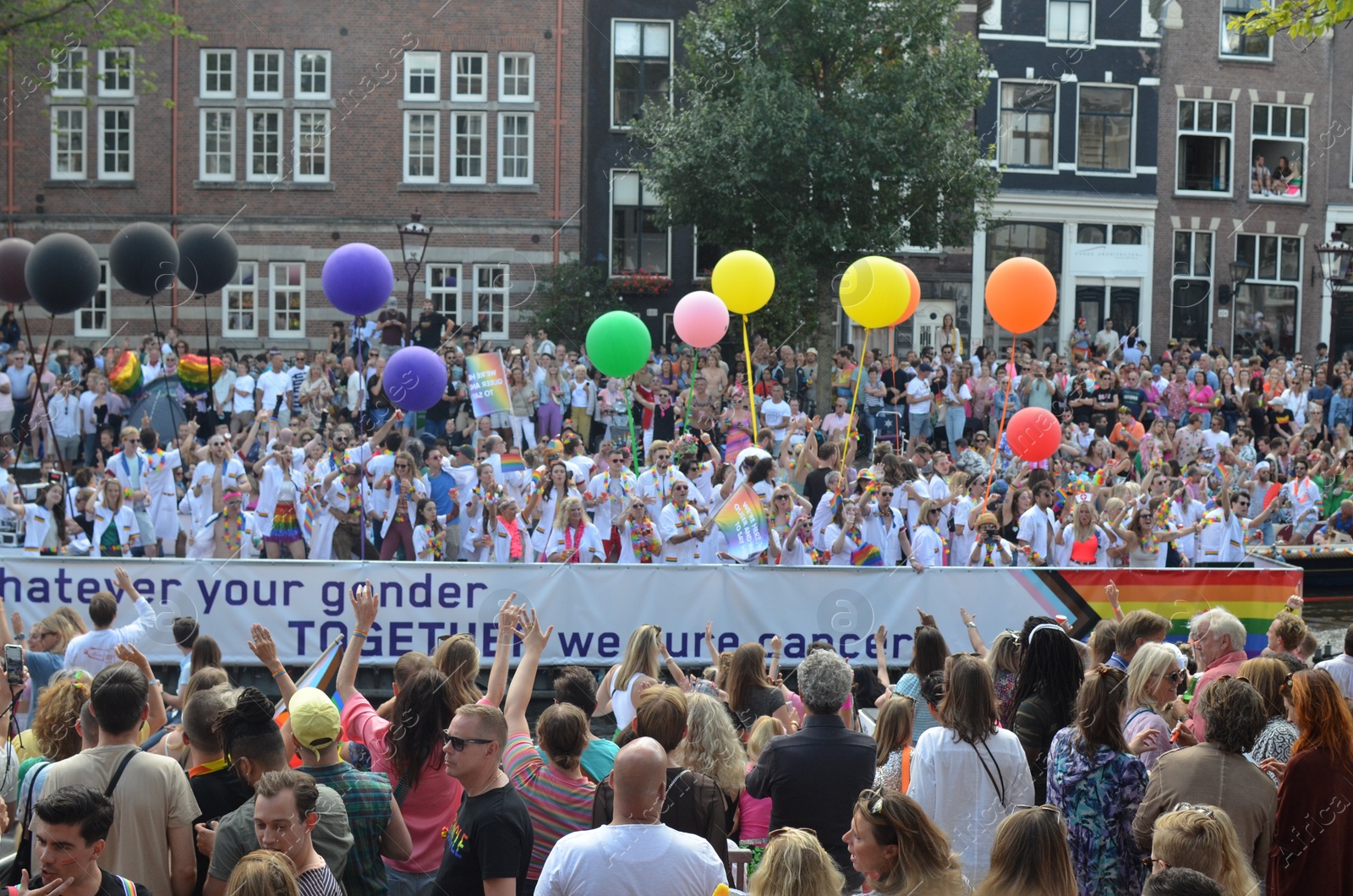 Photo of AMSTERDAM, NETHERLANDS - AUGUST 06, 2022: Many people at LGBT pride parade on summer day