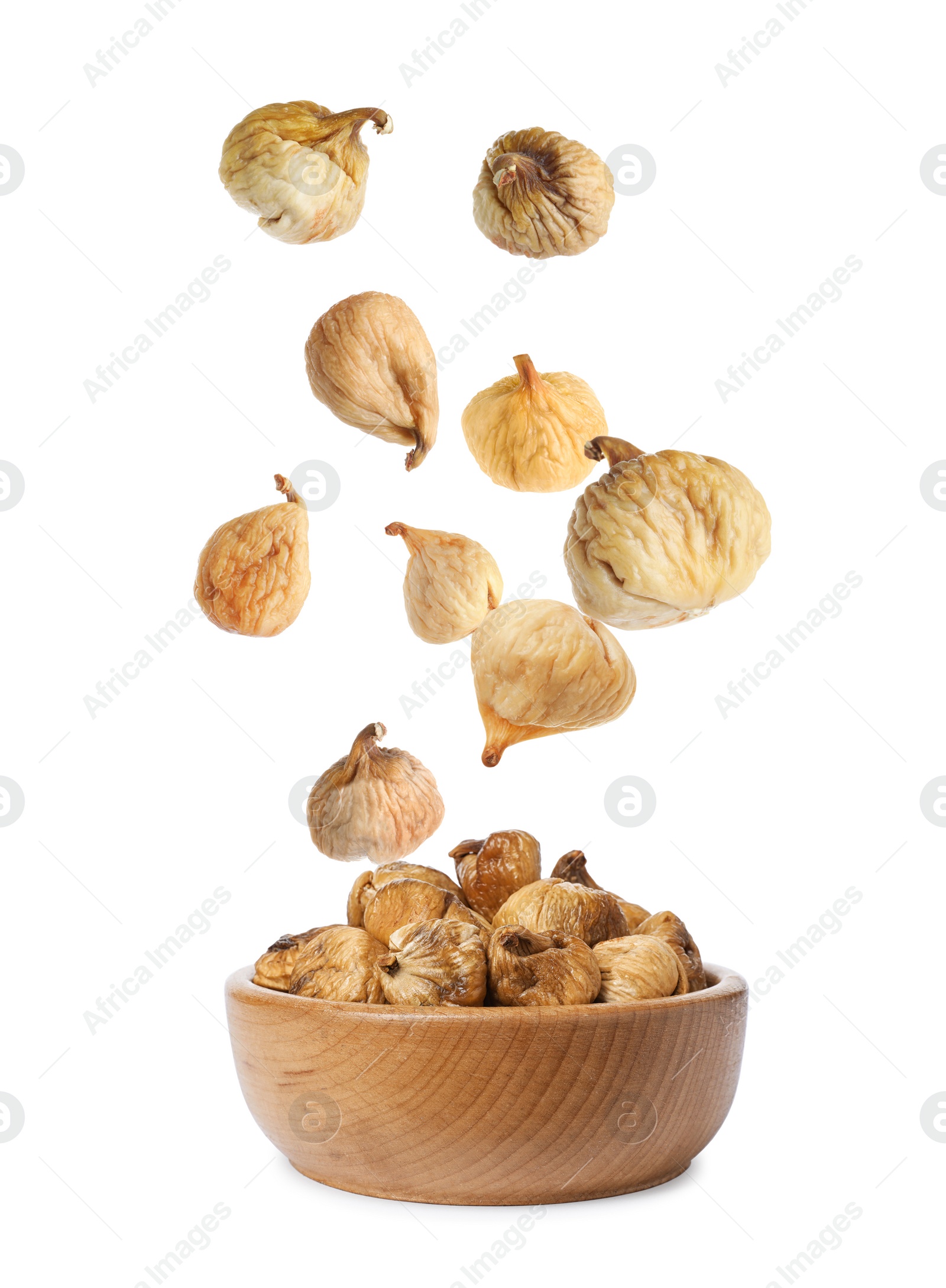 Image of Dried fig fruits falling into bowl on white background