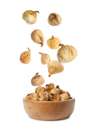 Image of Dried fig fruits falling into bowl on white background