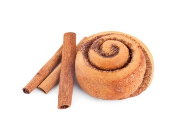 Photo of One tasty cinnamon roll and sticks isolated on white