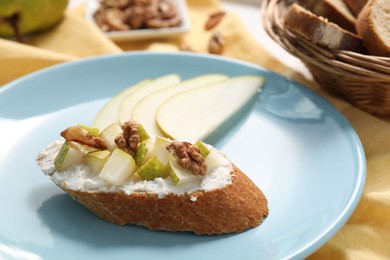 Delicious ricotta bruschetta with pear and walnut served on table, closeup