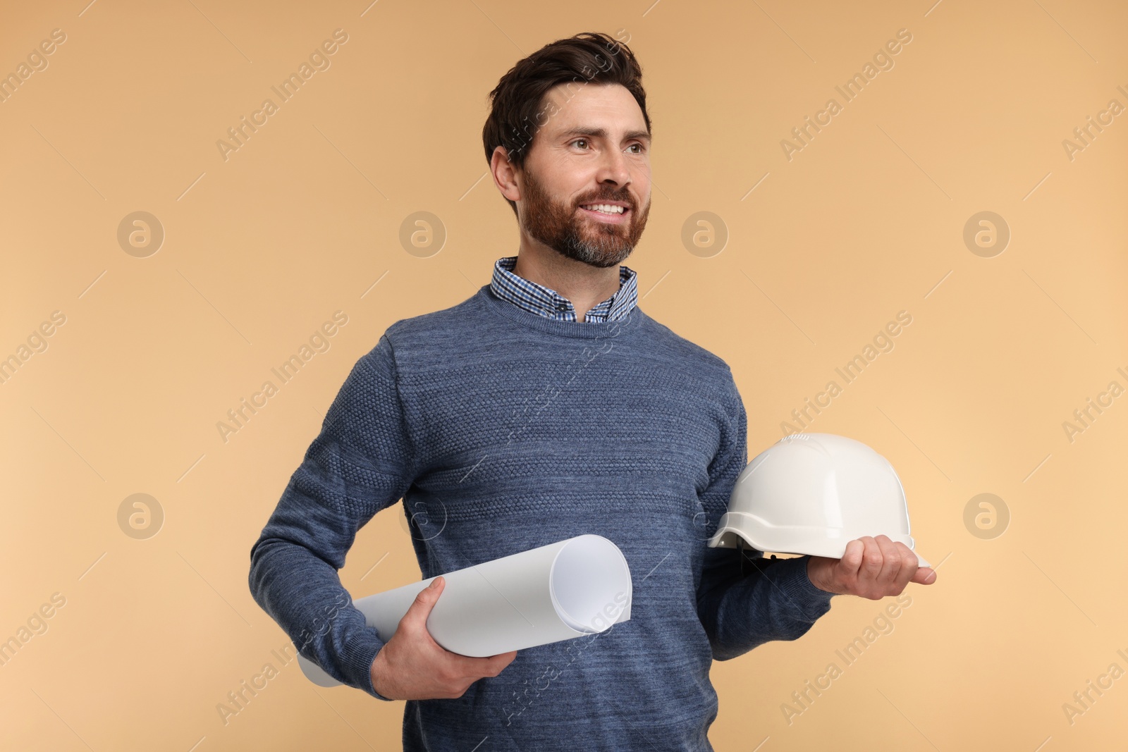 Photo of Architect with hard hat and draft on beige background