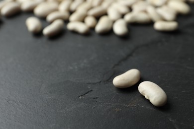 Raw beans on black background, closeup. Vegetable seeds