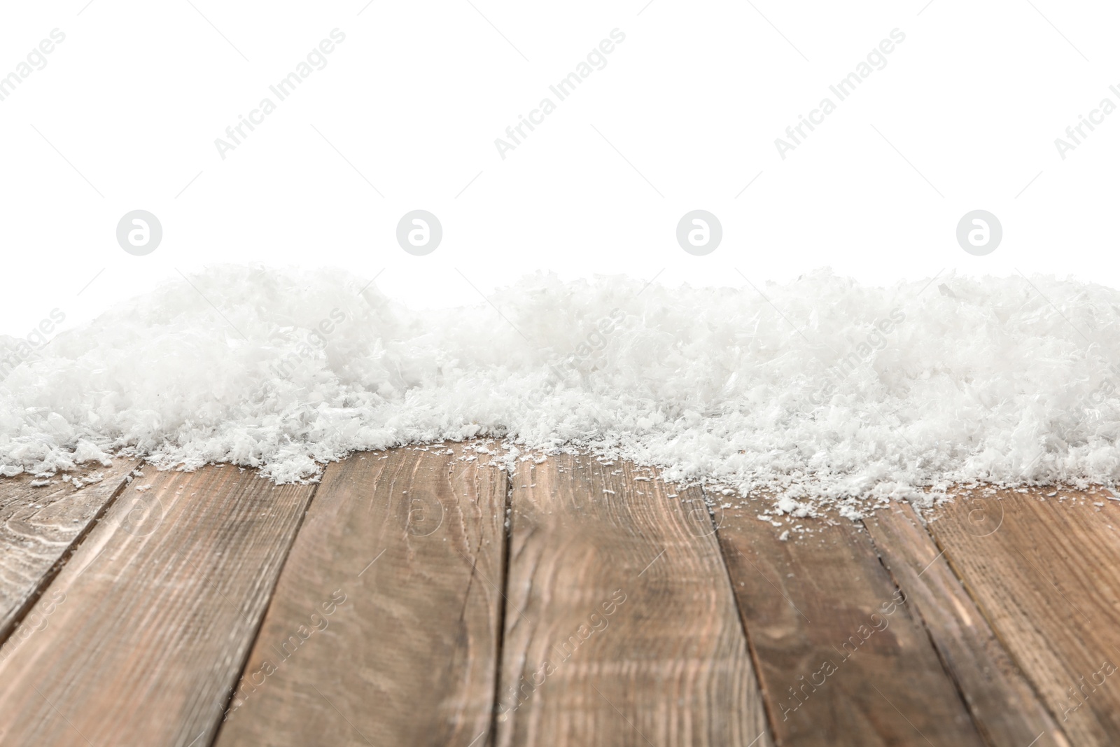 Photo of Snow on wooden surface against white background. Christmas season