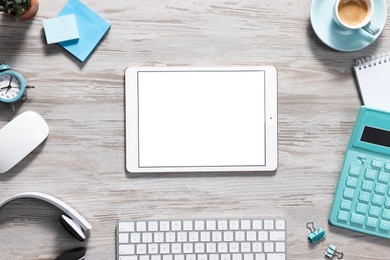 Photo of Flat lay composition with modern tablet on white wooden table. Space for text