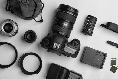 Flat lay composition with photographer's equipment and accessories on white background