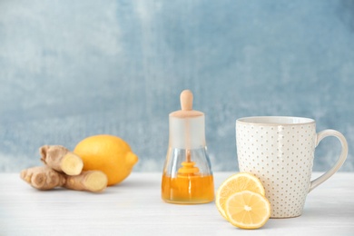 Cup of tea and lemon on table. Space for text