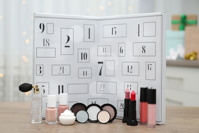 Photo of Advent calendar with different cosmetics and perfume on wooden table. Presents for Christmas