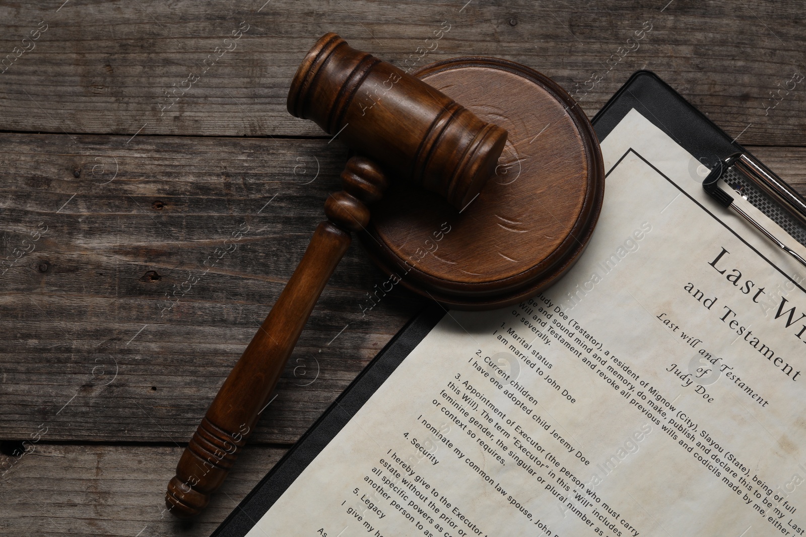 Photo of Last Will and Testament with gavel on wooden table, top view. Space for text