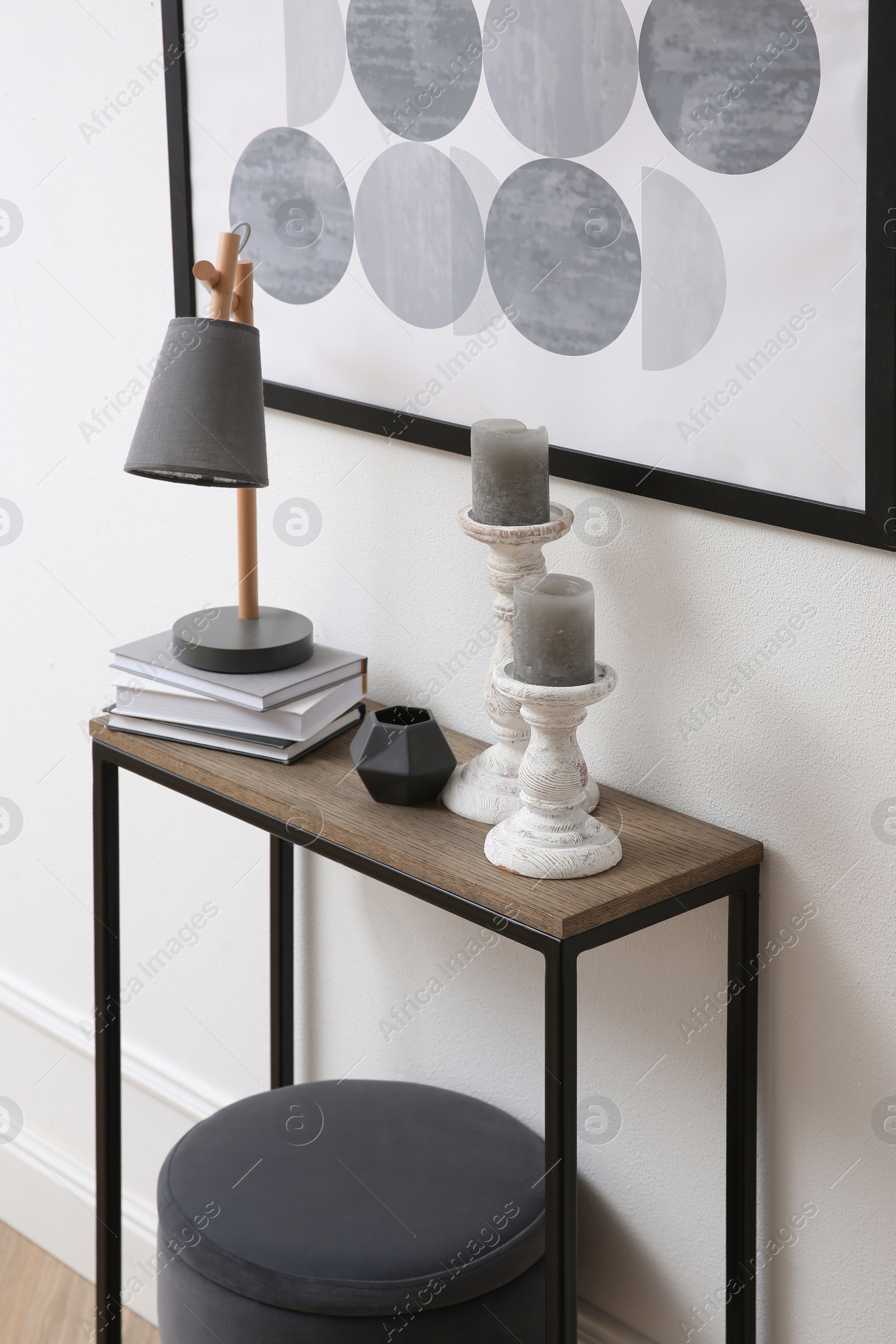 Photo of Hallway with stylish console table and picture. Interior design