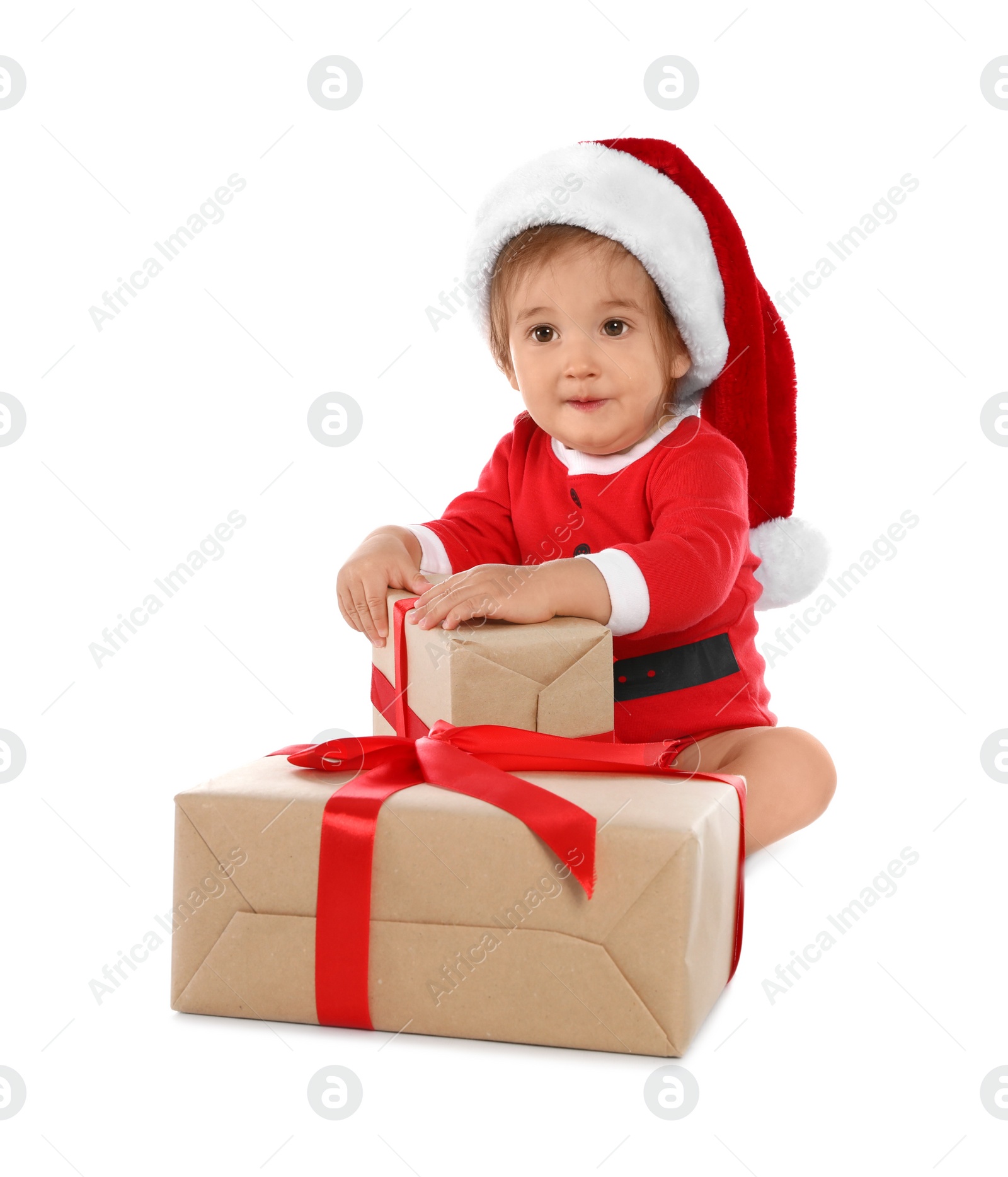 Photo of Festively dressed baby with gift boxes on white background. Christmas celebration