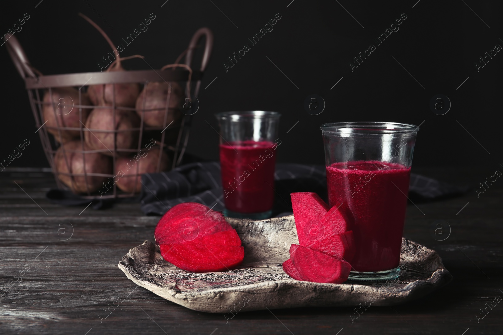 Photo of Plate with glass of beet smoothie on table