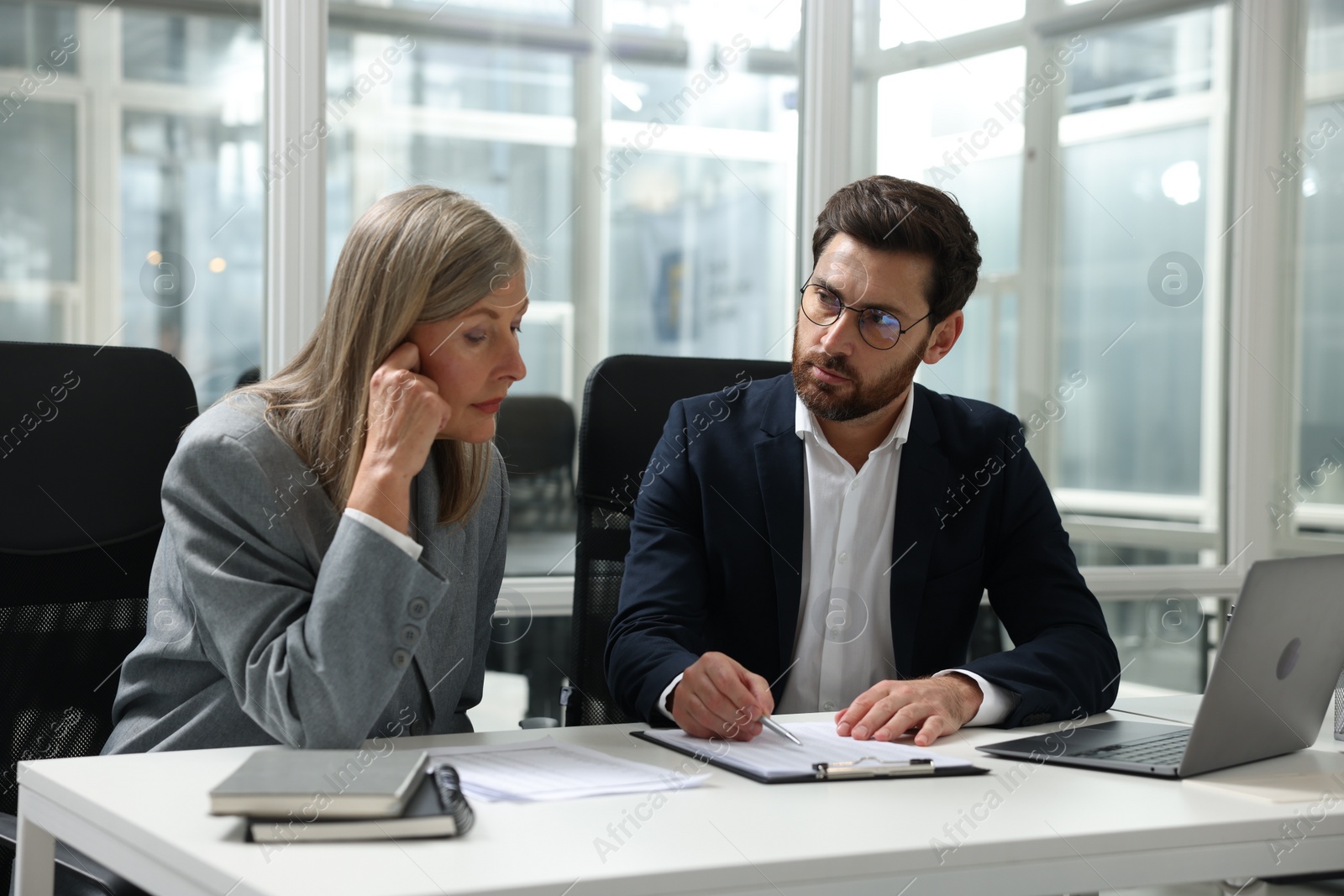 Photo of Lawyers working together at table in office