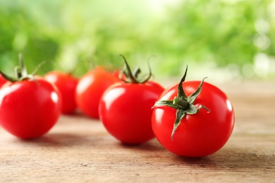 Fresh organic cherry tomatoes on wooden table