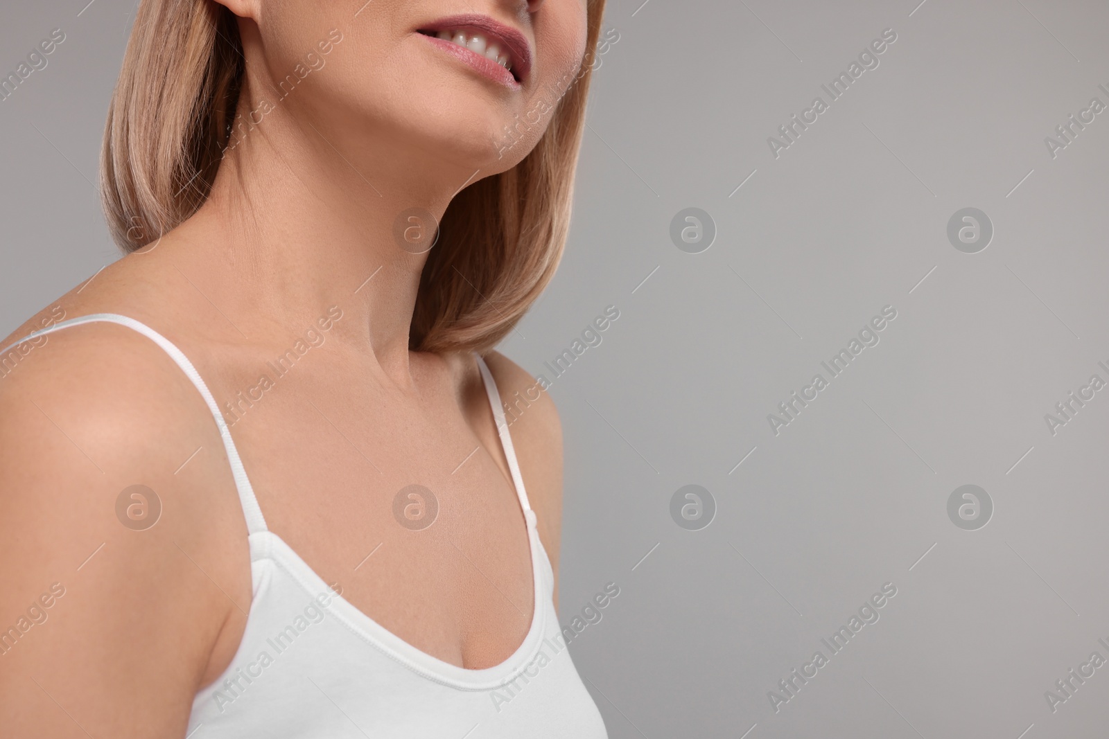 Photo of Woman with healthy skin on grey background, closeup. Space for text