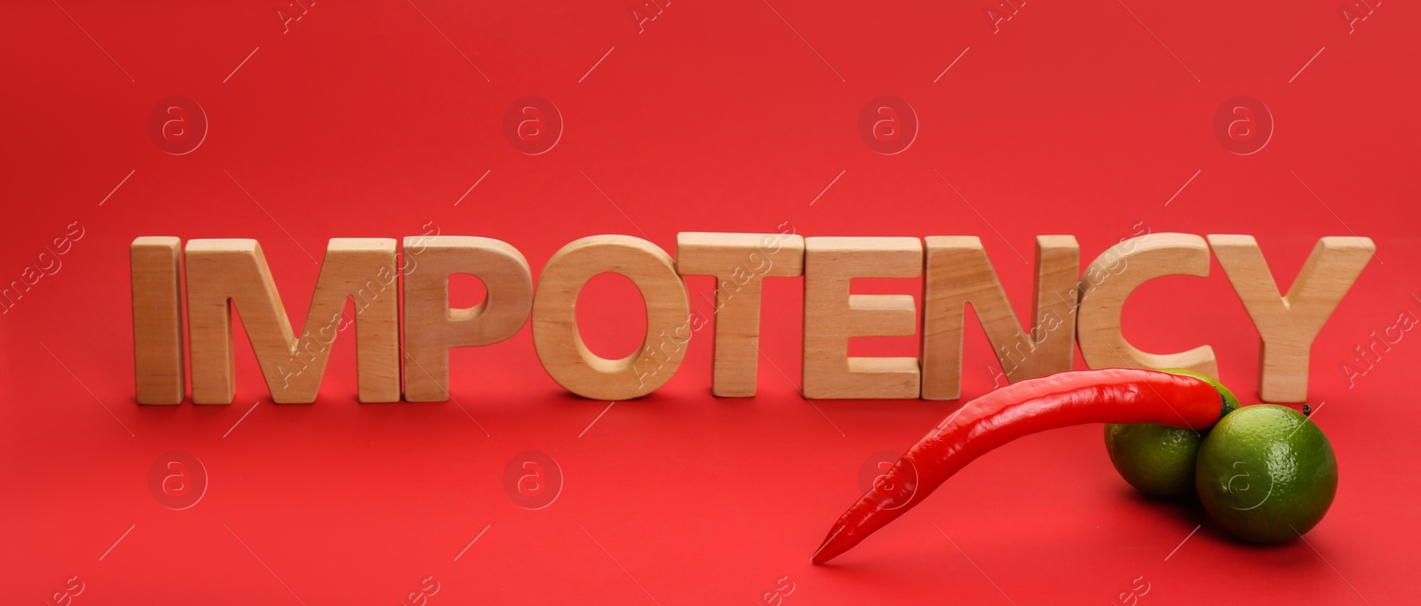 Photo of Word IMPOTENCY made of wooden letters and products symbolizing male sexual organ on red background