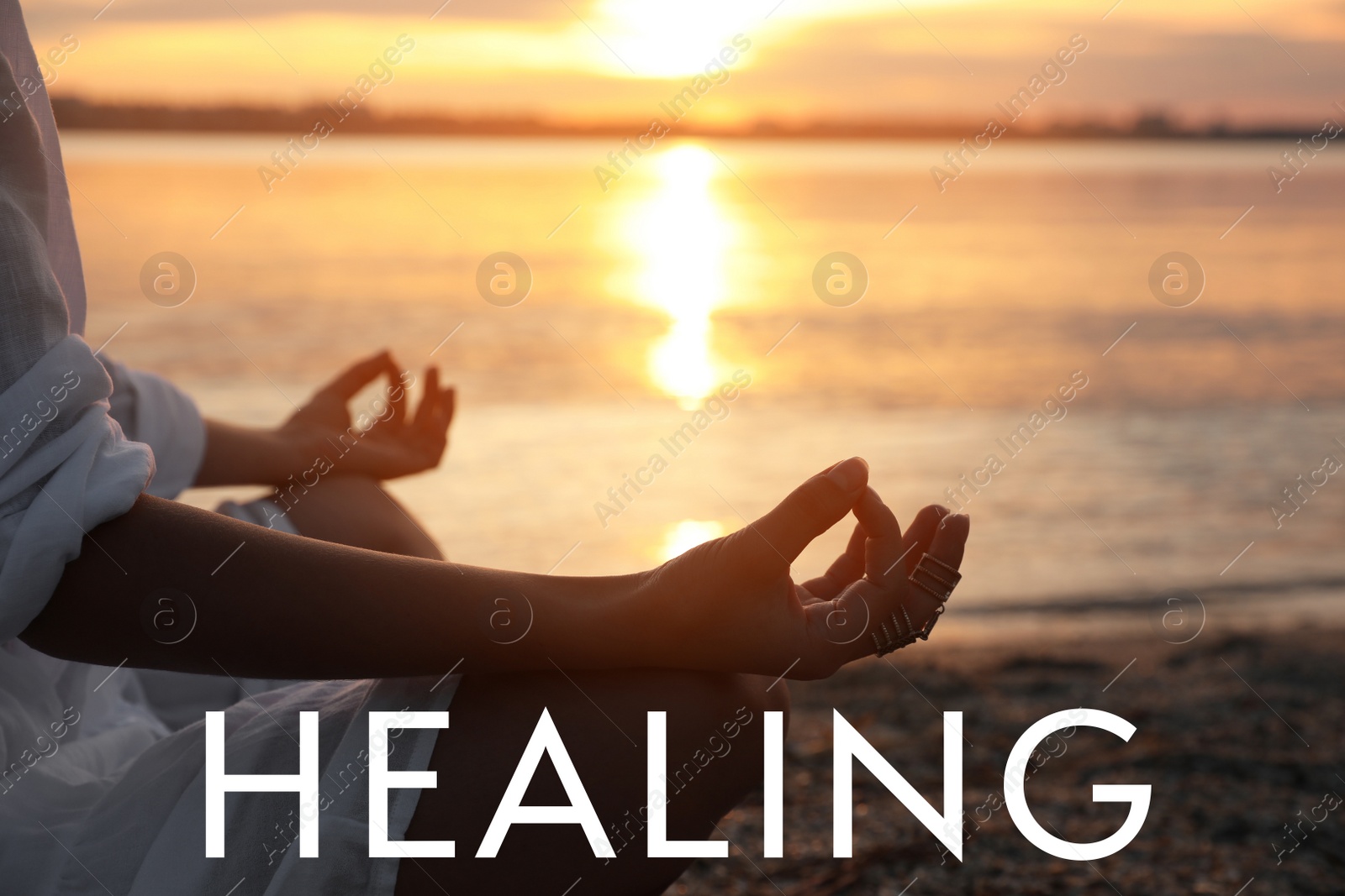 Image of Young woman meditating near river at sunset, closeup. Nature healing power