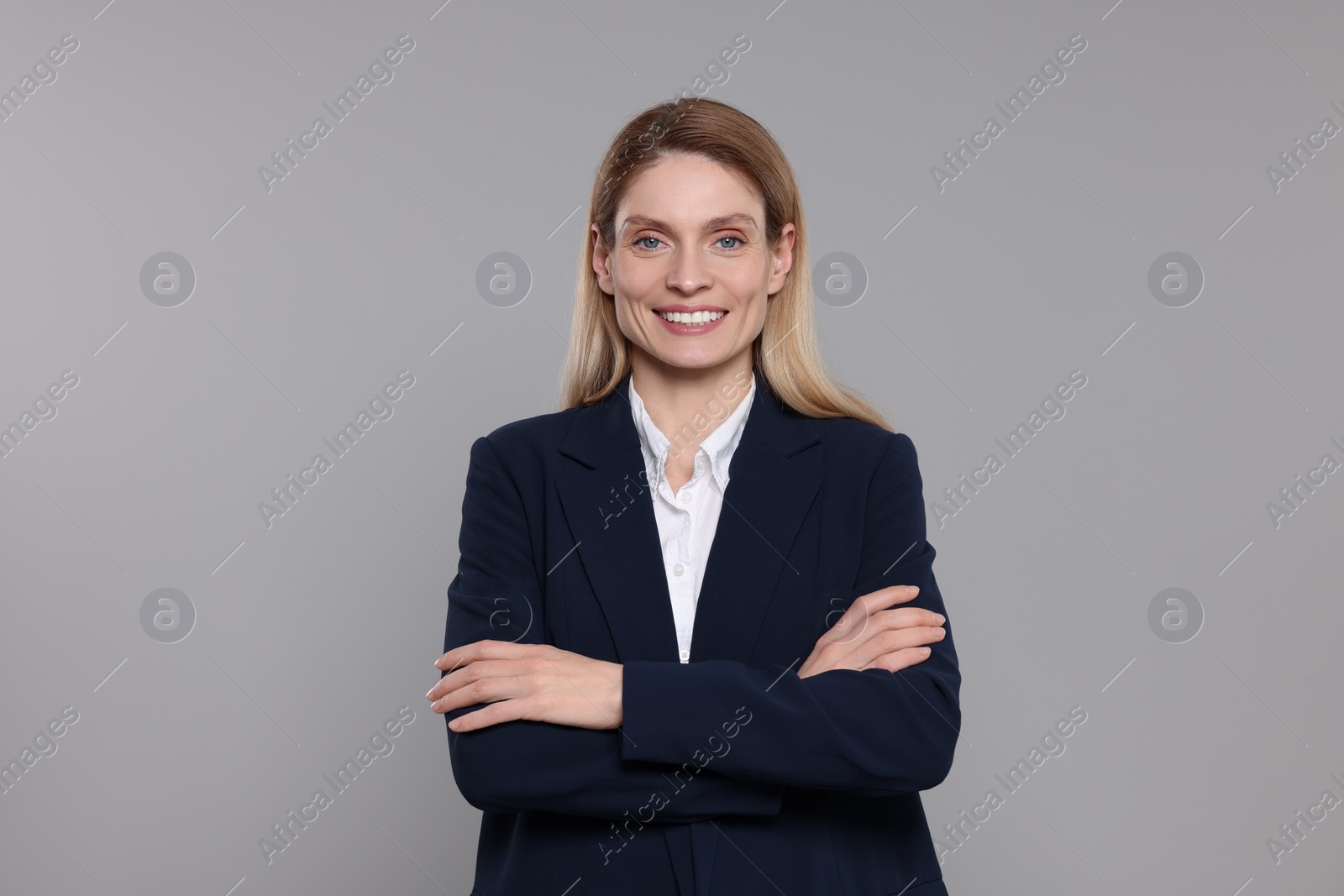 Photo of Happy real estate agent on grey background