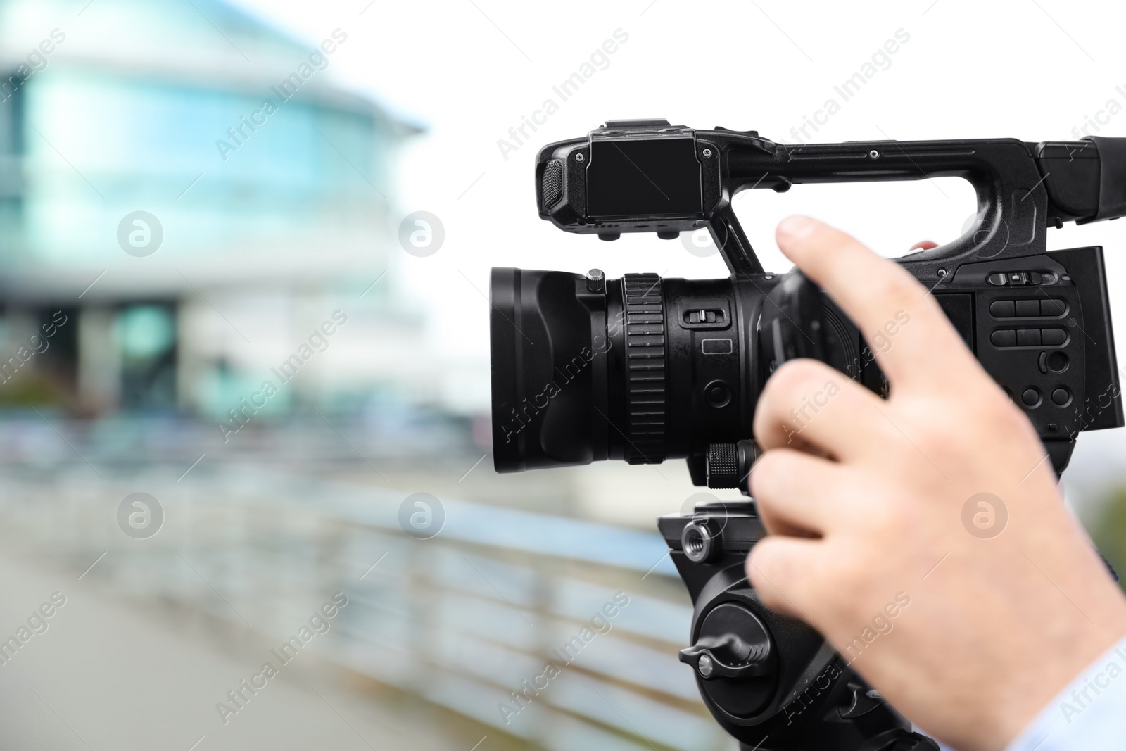 Photo of Video operator with camera working on city street, closeup