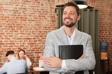 Portrait of office employee at workplace, space for text