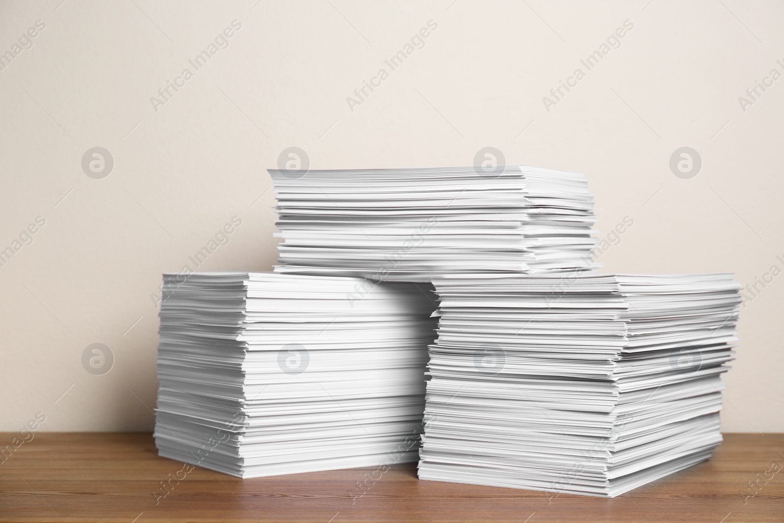 Photo of Stacks of paper sheets on wooden table