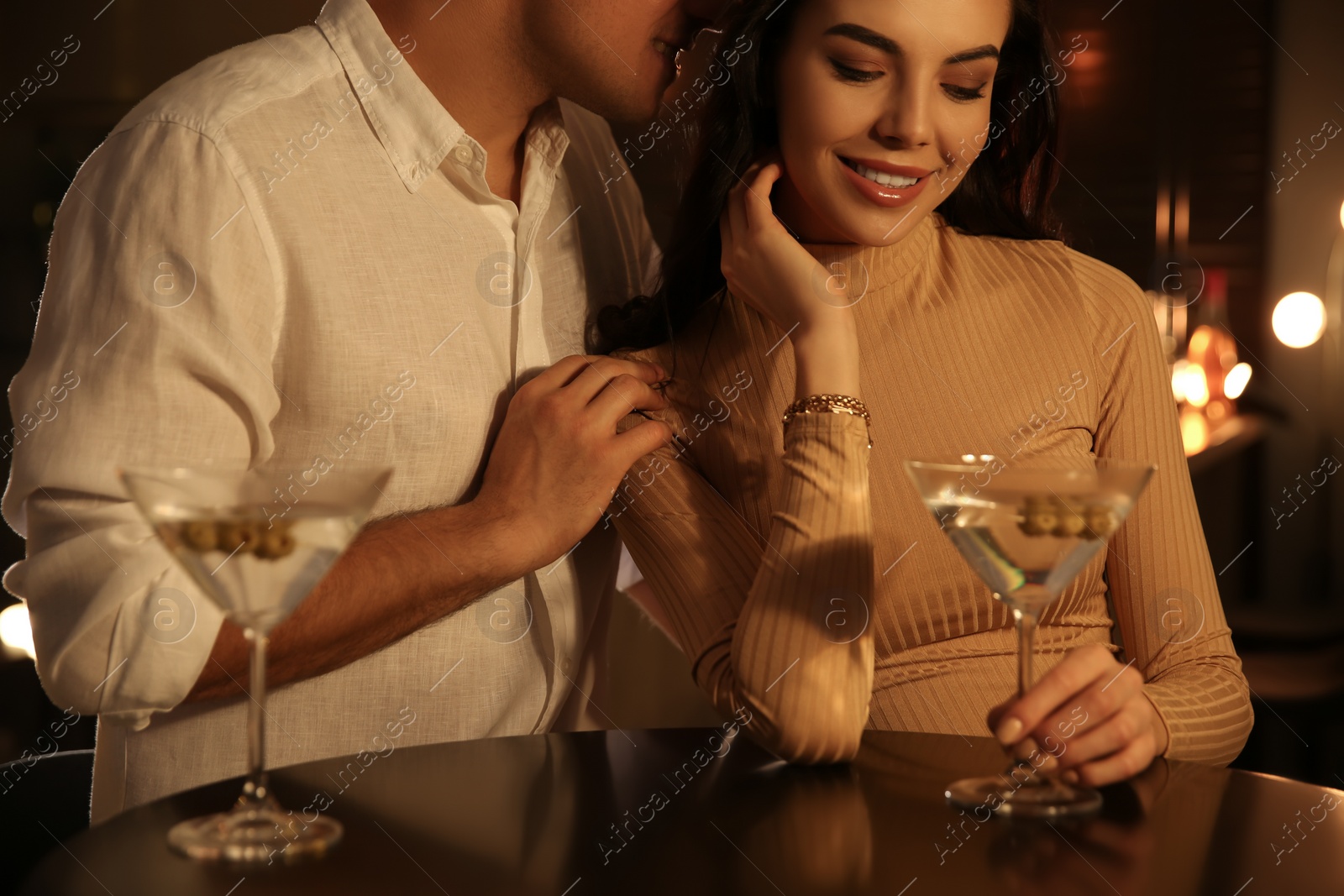 Photo of Man and woman flirting with each other in bar, closeup