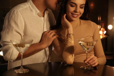 Photo of Man and woman flirting with each other in bar, closeup