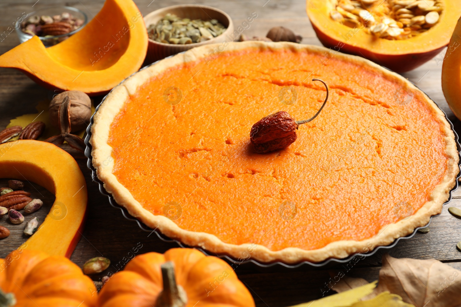 Photo of Delicious homemade pumpkin pie on wooden table