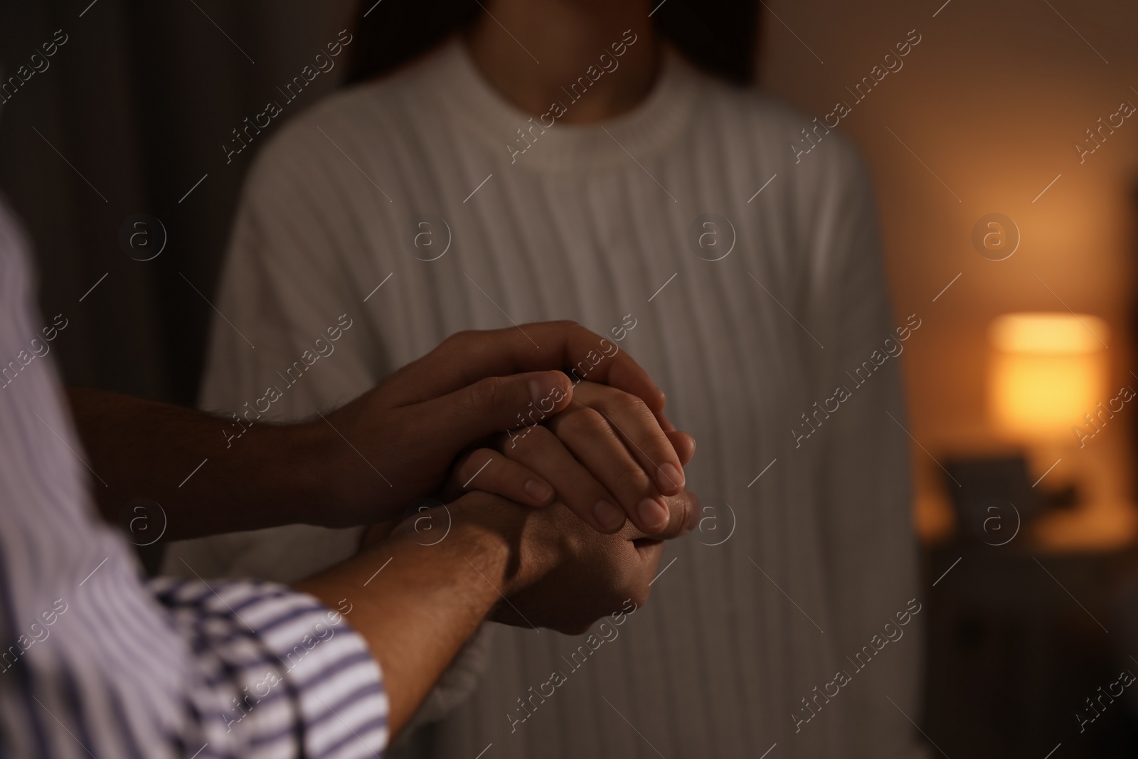 Photo of Man giving helping hand to woman indoors, closeup