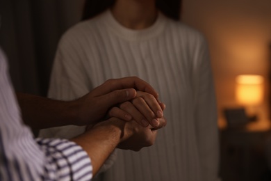 Man giving helping hand to woman indoors, closeup