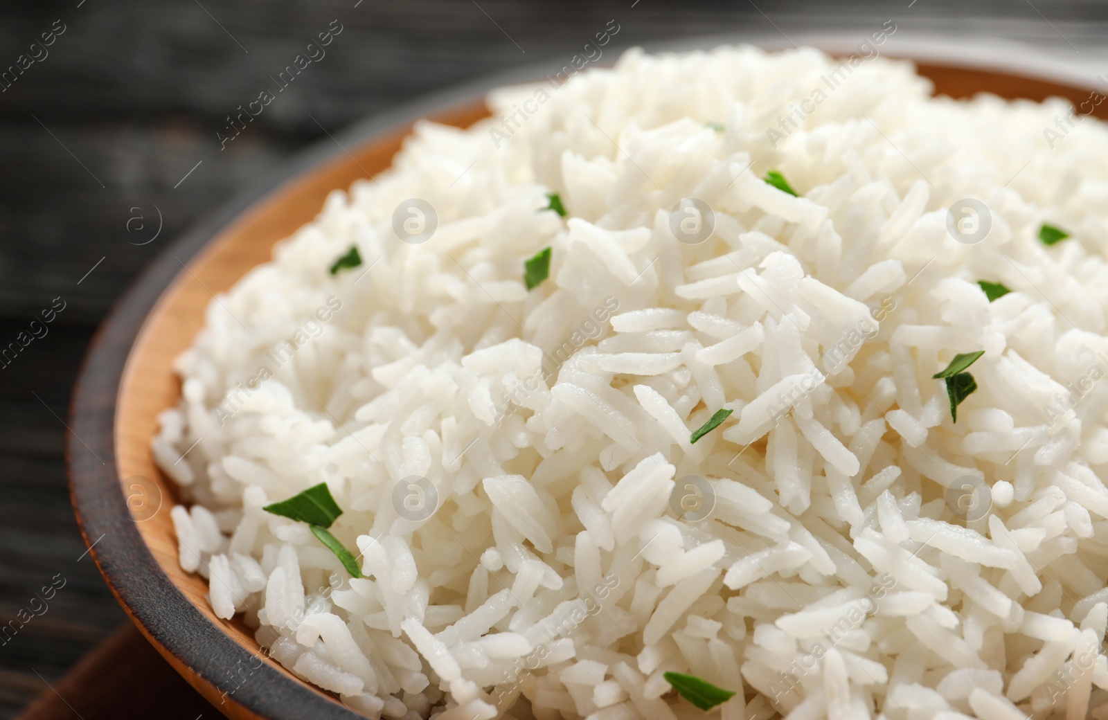 Photo of Plate of tasty cooked white rice on table, closeup