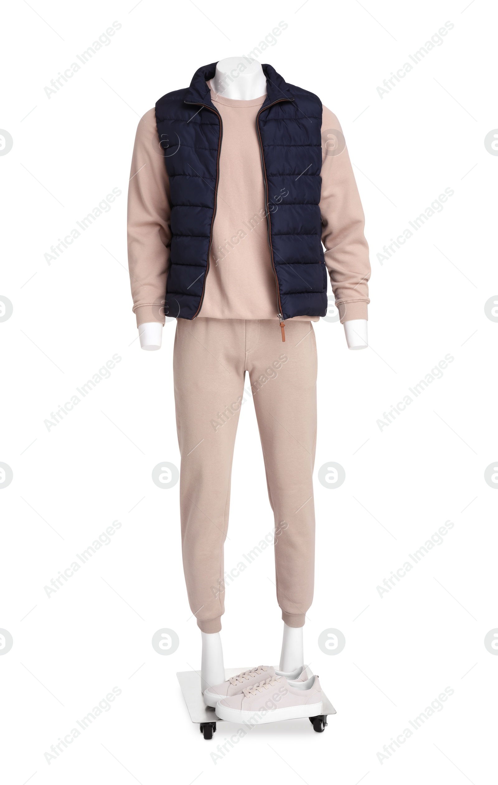 Photo of Male mannequin with shoes dressed in stylish beige tracksuit and vest isolated on white