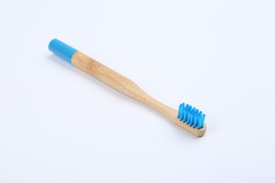 Photo of Bamboo toothbrush with blue bristle isolated on white