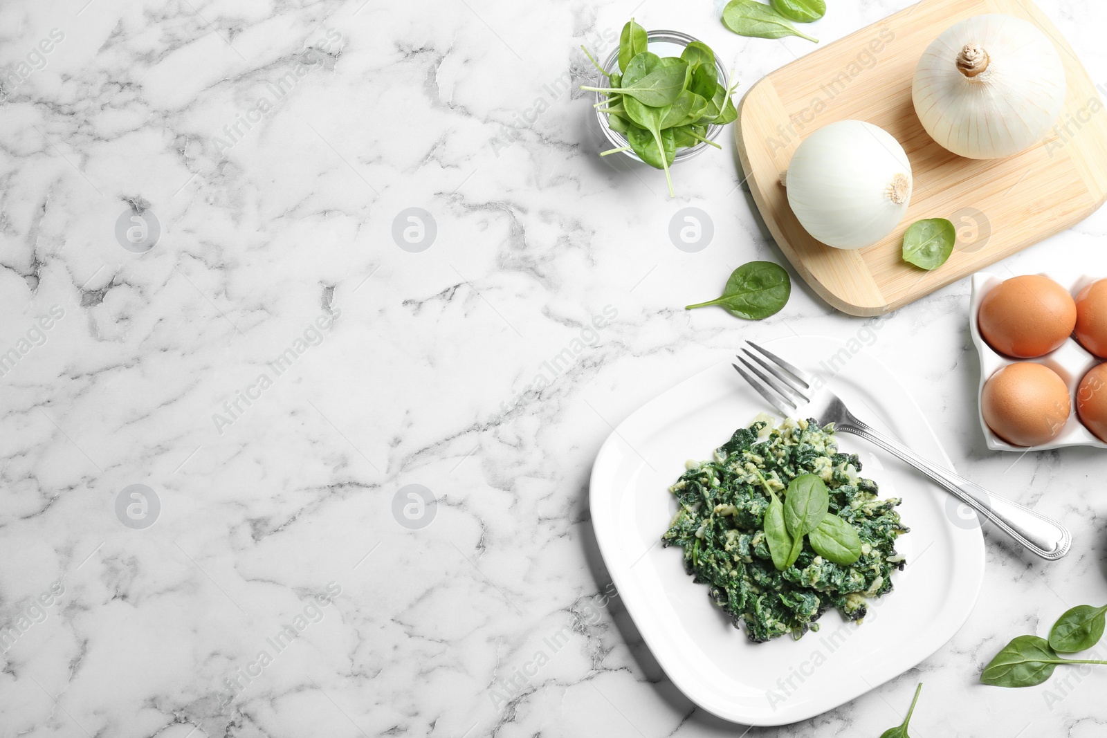 Photo of Flat lay composition with tasty spinach and space for text on white marble table. Healthy food