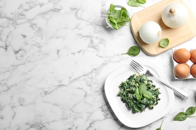 Flat lay composition with tasty spinach and space for text on white marble table. Healthy food