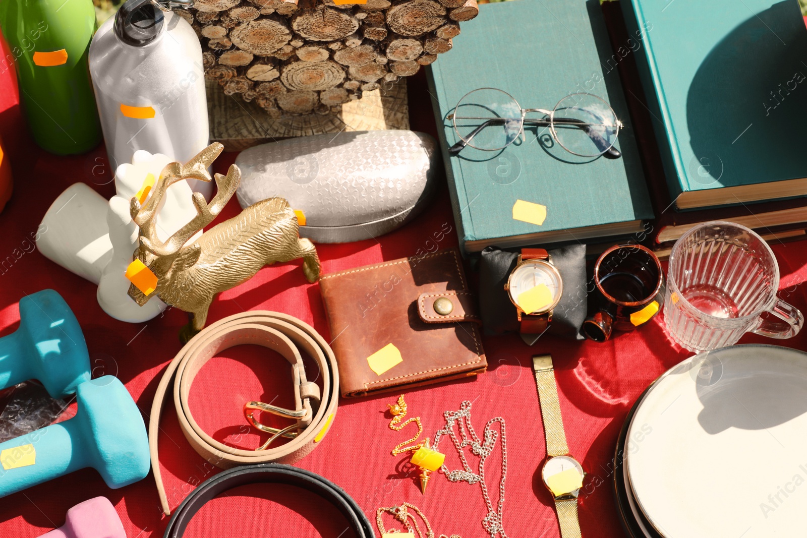 Photo of Many different items on table outdoors, above view. Garage sale