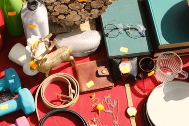 Many different items on table outdoors, above view. Garage sale