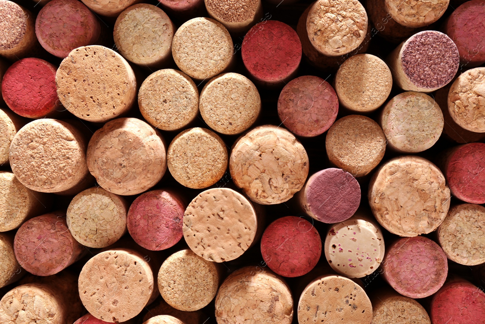 Photo of Many corks of wine bottles as background, top view