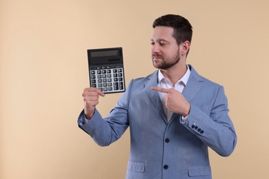 Happy accountant with calculator on beige background. Space for text