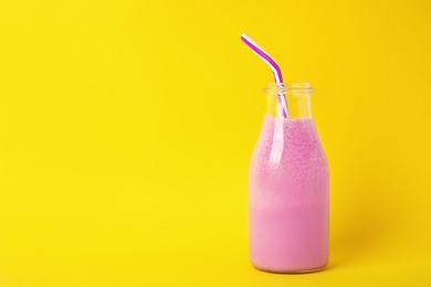 Photo of Bottle of tasty milk shake and space for text on color background