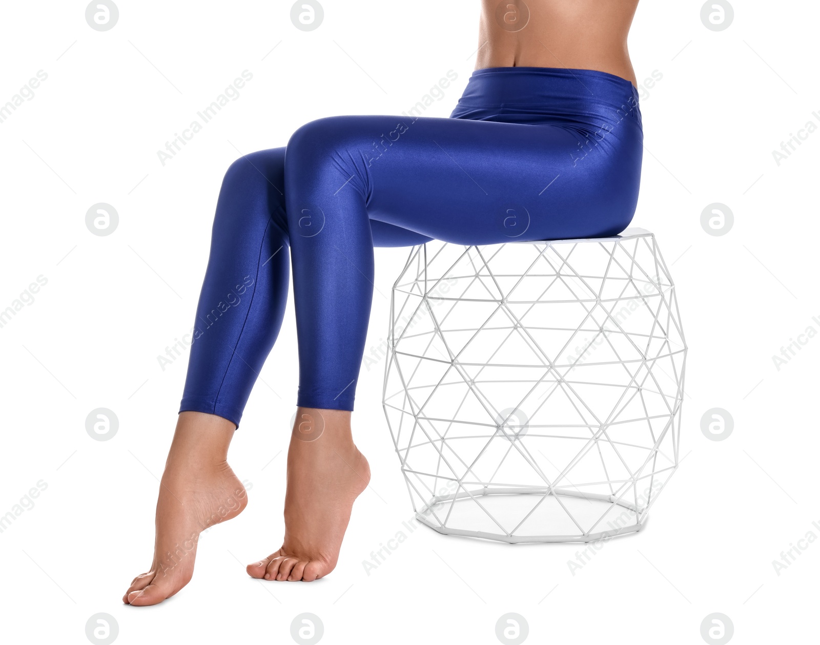 Photo of Woman with beautiful long legs wearing blue leggings on white background, closeup