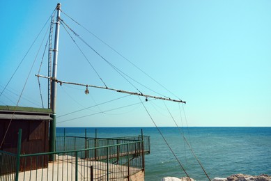 Shore operated stationary lift net on coast