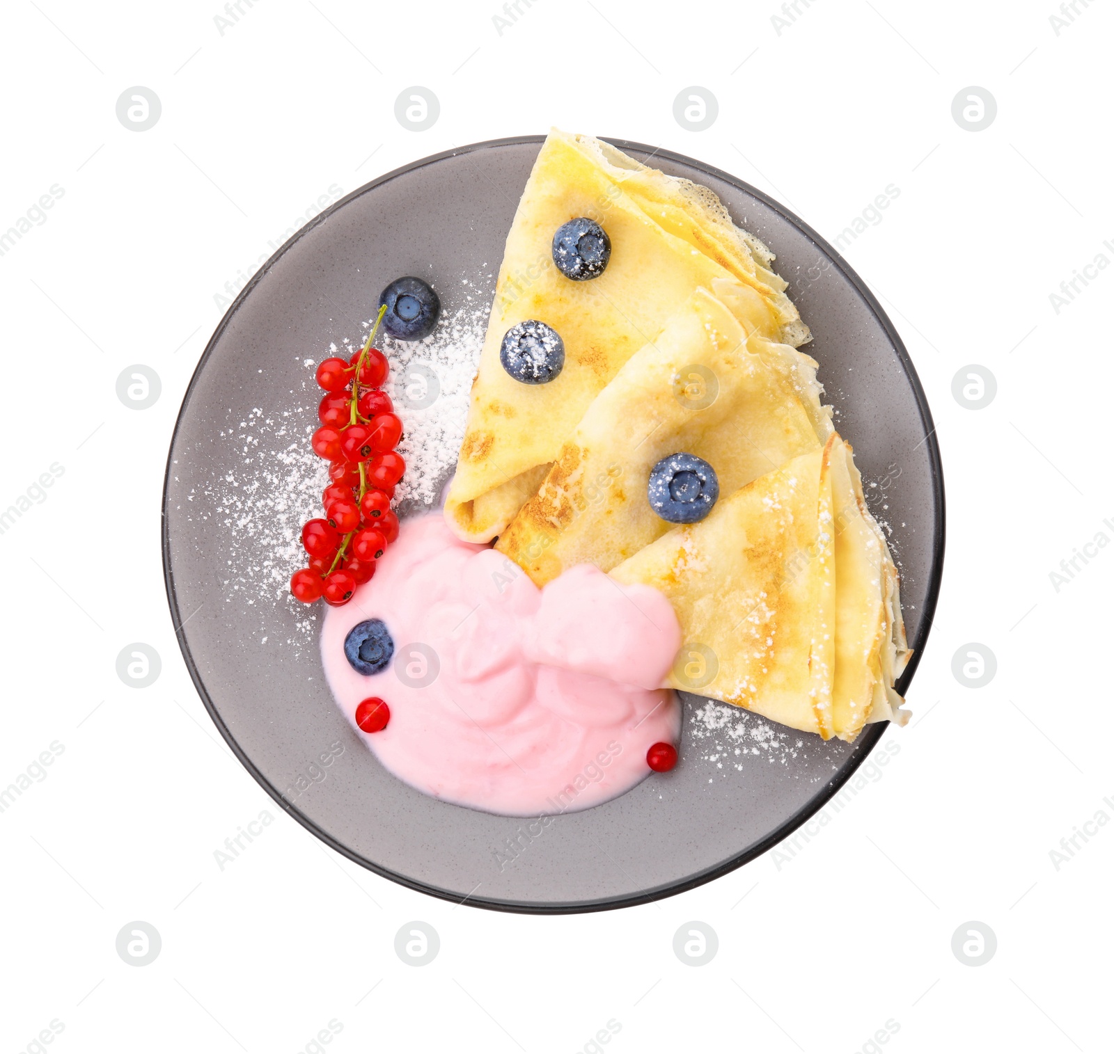 Photo of Delicious crepes with natural yogurt, blueberries and red currants on white background