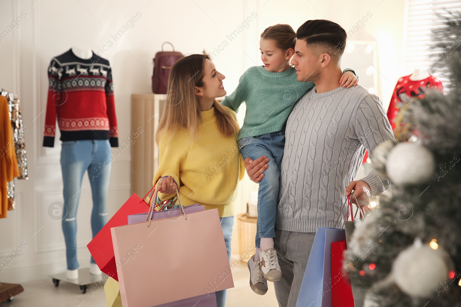 Photo of Happy family doing Christmas shopping in store