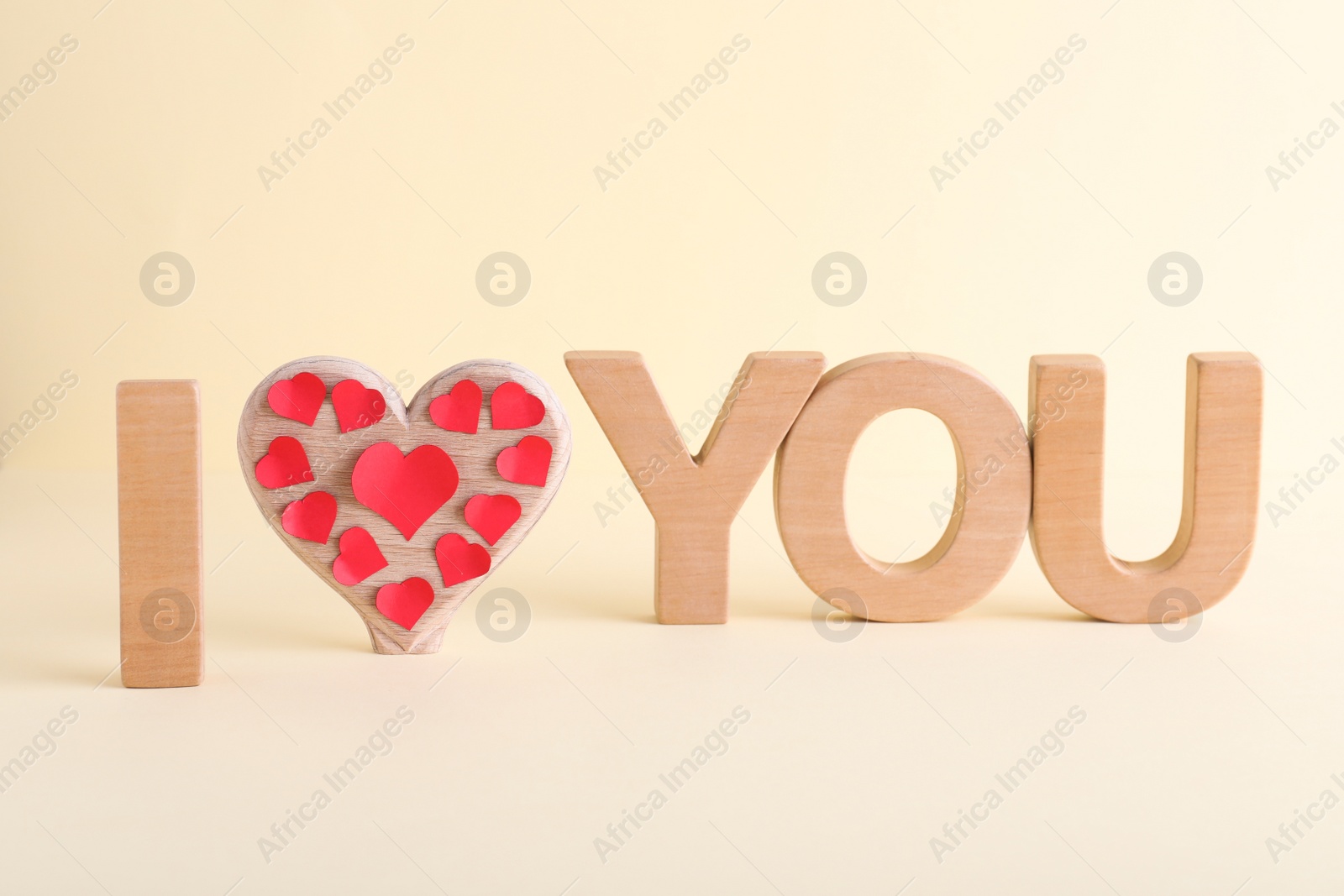 Photo of Phrase I Love You made of wooden letters on light background